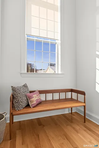 a view of a hallway with wooden floor and staircase