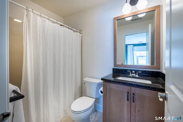 a bedroom with a bed and a table with closet