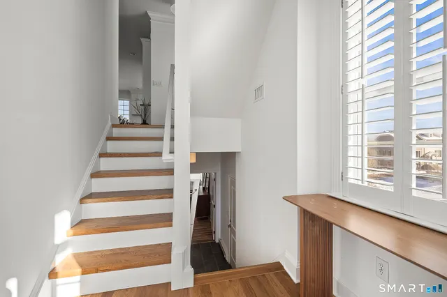 a bedroom with a bed and a lamp