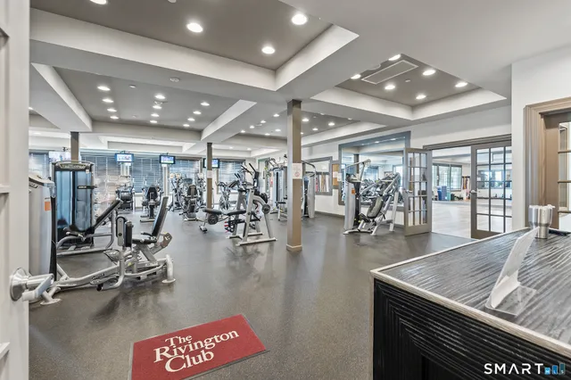 a living room with fireplace furniture and a wooden floor