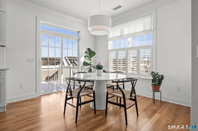 a view of a dining room with furniture window and wooden floor