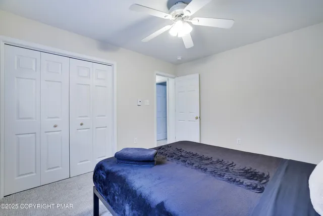 a spacious bedroom with a bed and a window