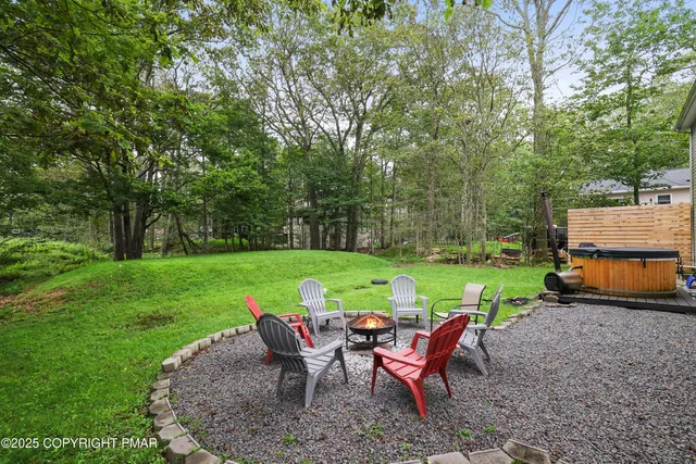 a view of a table and chairs in backyard