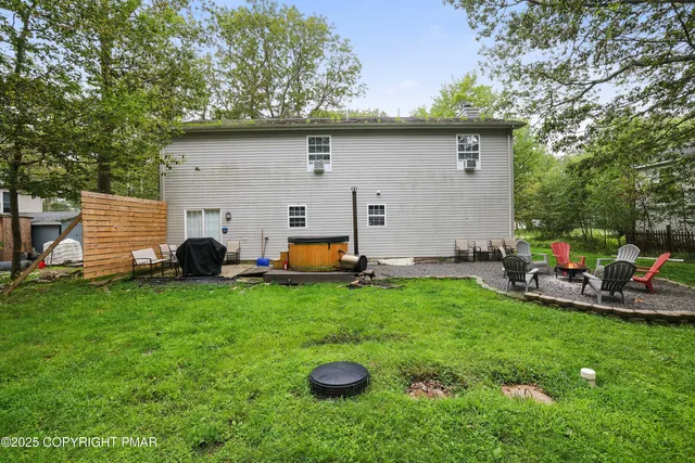 a backyard of a house with table and chairs