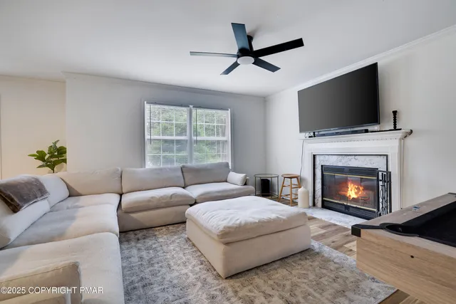 a living room with furniture a fireplace and a flat screen tv