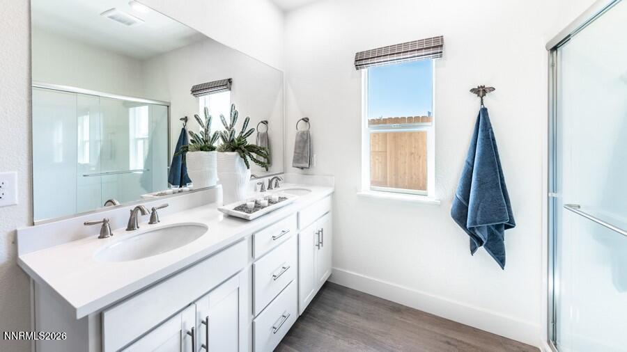 497 Radiant Drive Carson City, NV 89705 - Photo 18 of 23 a bathroom with a double vanity sink and a mirror