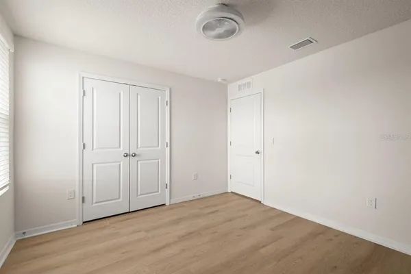 a view of a room with wooden floor and a sink