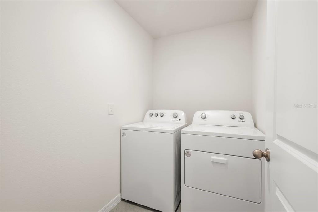 7782 Sail Clover Lane Zephyrhills, FL 33540 - Photo 18 of 22 a utility room with dryer and washer
