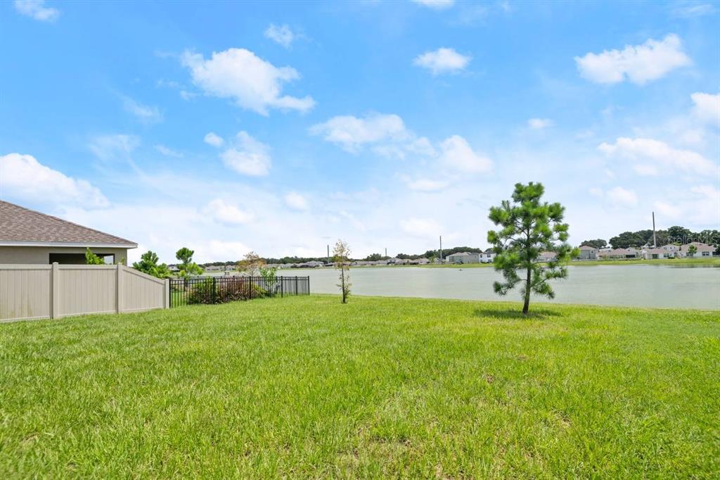 7782 Sail Clover Lane Zephyrhills, FL 33540 - Photo 21 of 22 a swimming pool with an outdoor space and seating area