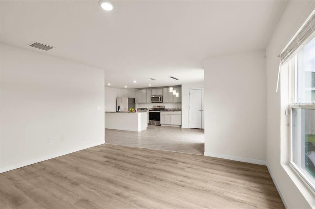 7782 Sail Clover Lane Zephyrhills, FL 33540 - Photo 5 of 22 a view of a kitchen with wooden floor and windows