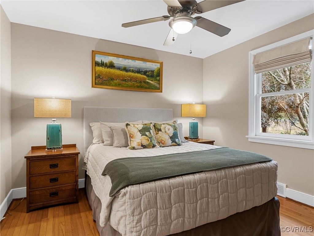 8654 Fieldcrest Road Richmond, VA 23235 - Photo 24 of 48 a bedroom with a bed and wooden floor