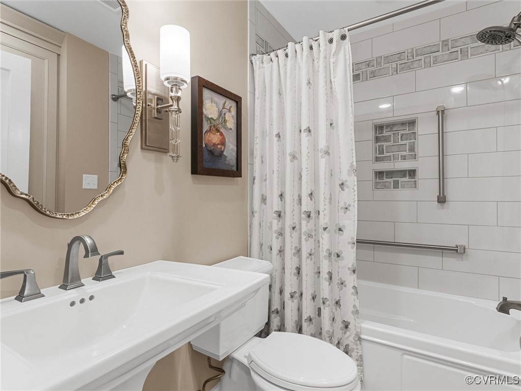 8654 Fieldcrest Road Richmond, VA 23235 - Photo 28 of 48 a bathroom with a sink toilet and shower
