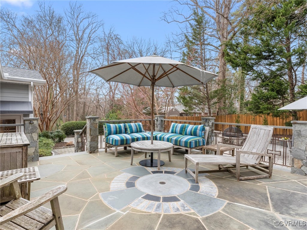 8654 Fieldcrest Road Richmond, VA 23235 - Photo 42 of 48 a view of a patio with a table and chairs under an umbrella
