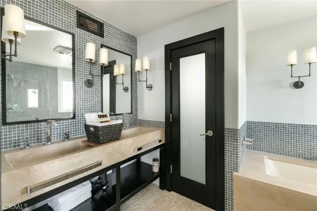 a bathroom with a sink a mirror and shower