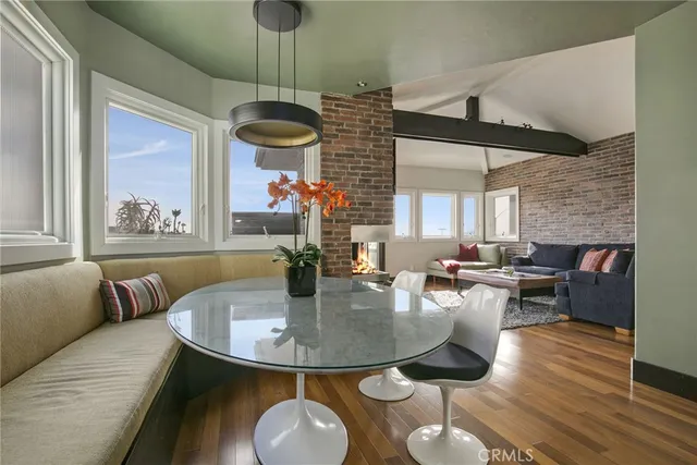 a dining room with furniture and wooden floor