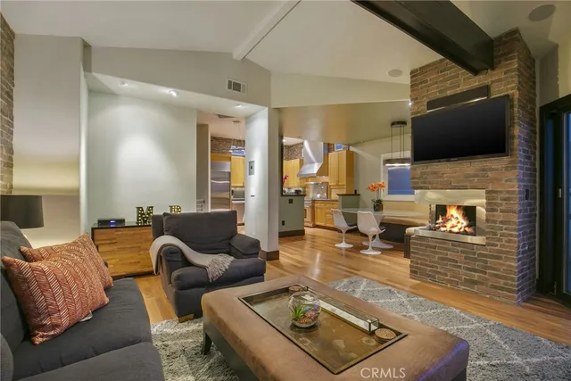 a living room with fireplace furniture and a flat screen tv