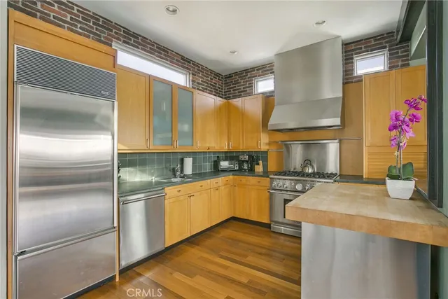 a kitchen with a refrigerator sink and stove