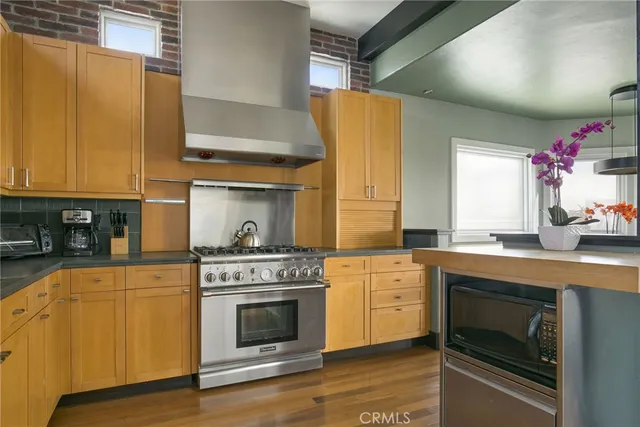 a kitchen with a stove top oven and cabinets