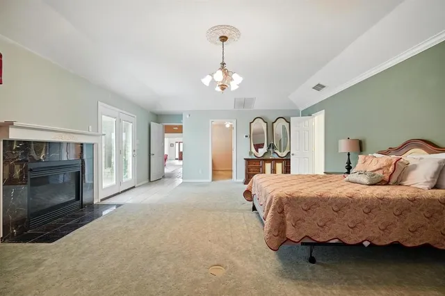a bedroom with bed and a chandelier