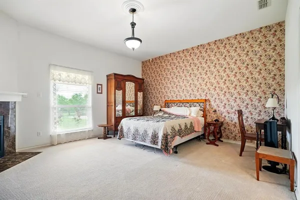 a spacious bedroom with a bed and a window