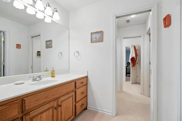 a bathroom with a sink vanity and mirror