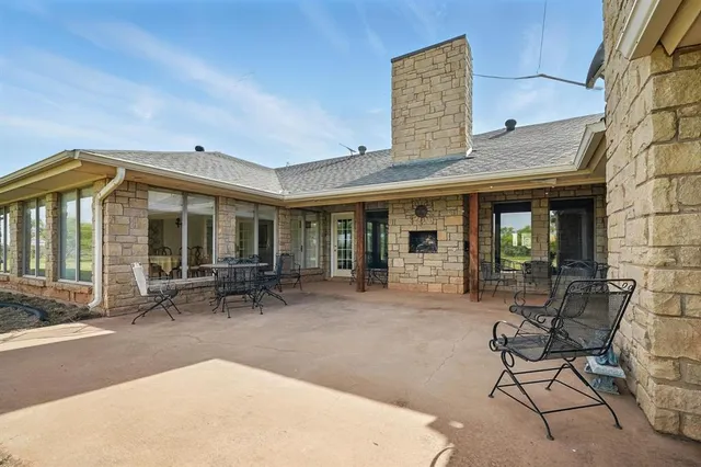 a brick house with table and chairs in front of it