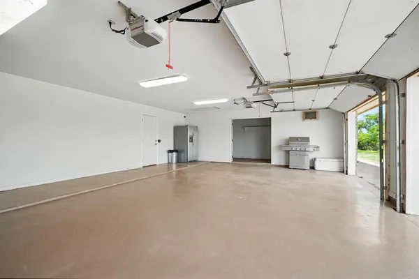 an empty room with windows and ceiling fan