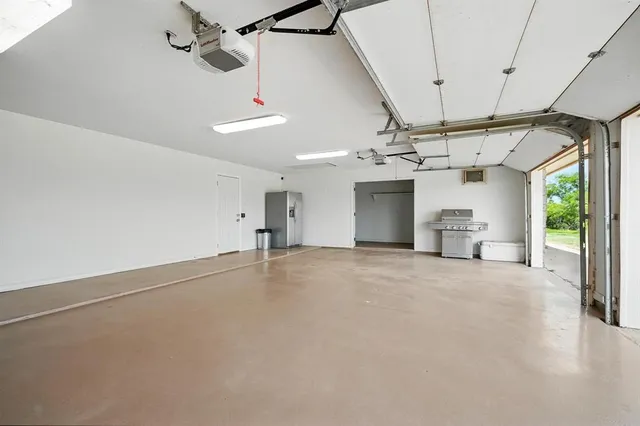 an empty room with windows and ceiling fan