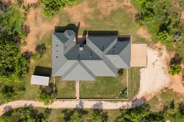 an aerial view of a house with yard