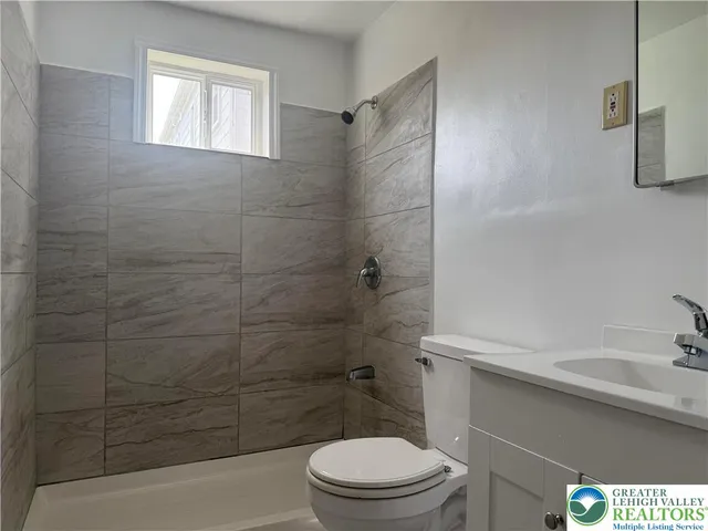 a bathroom with a toilet a sink and shower