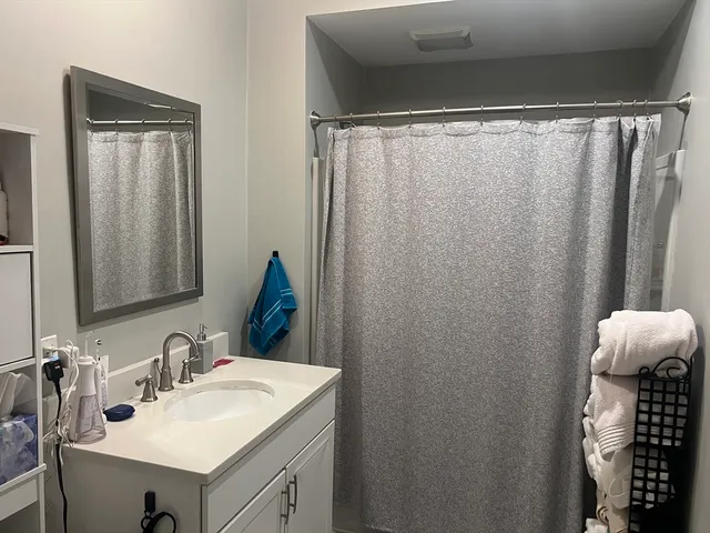 a bathroom with a sink vanity and a mirror