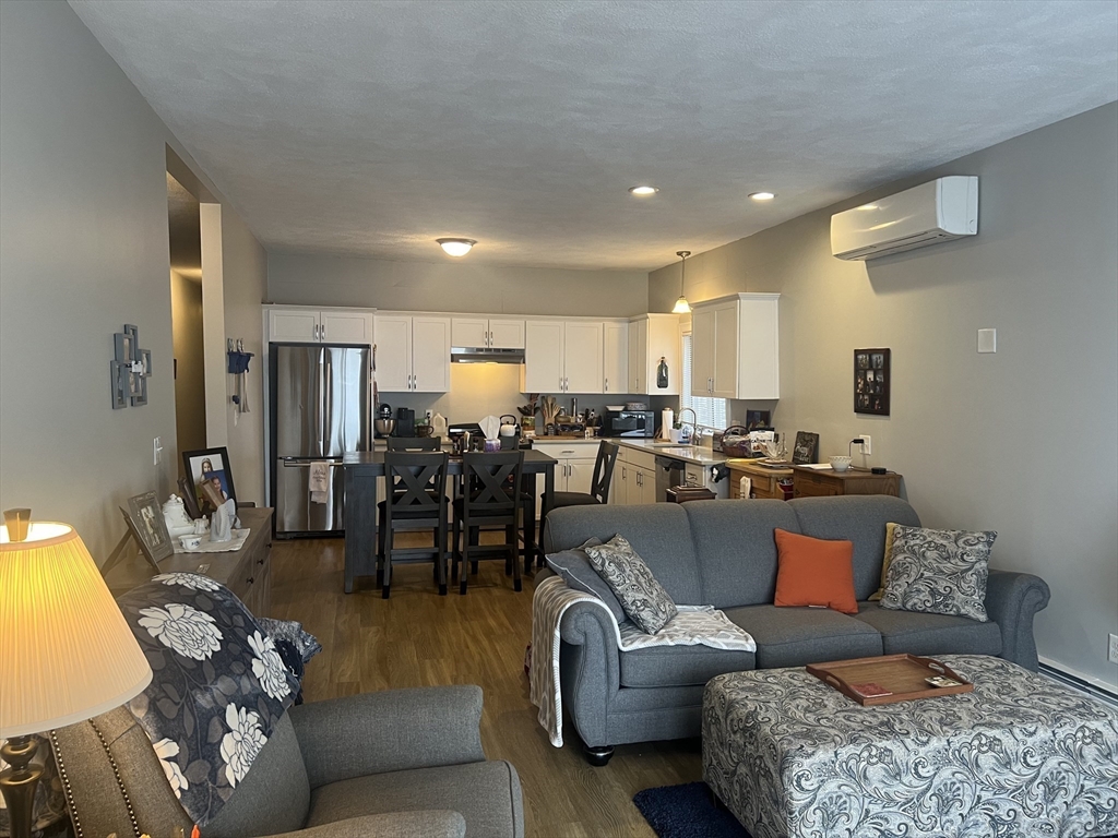 50 Humphrey Street, Unit 1 Swampscott, MA 01907 - Photo 5 of 12 a living room with furniture kitchen view and a large window
