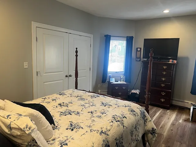 a bedroom with a bed and a dresser