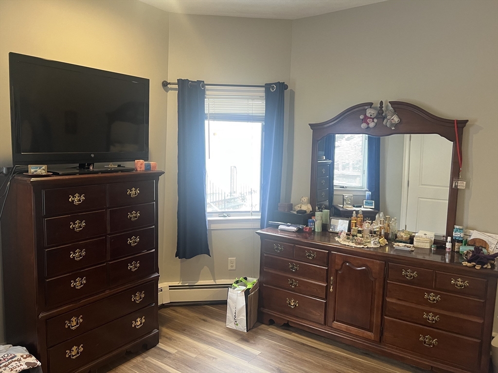50 Humphrey Street, Unit 1 Swampscott, MA 01907 - Photo 10 of 12 a living room with furniture and a flat screen tv