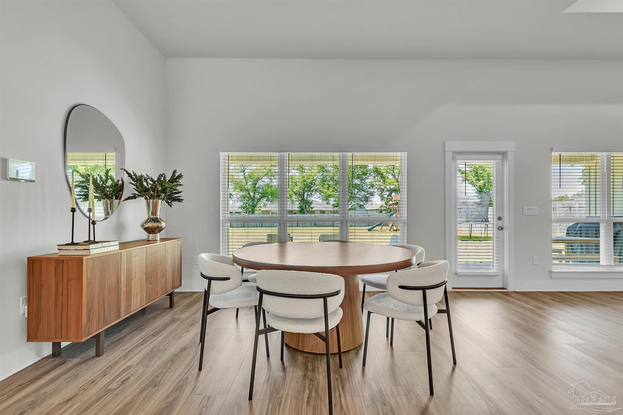 5531 Blake Lane Pace, FL 32571 - Photo 15 of 43 a view of a dining room with furniture window and wooden floor