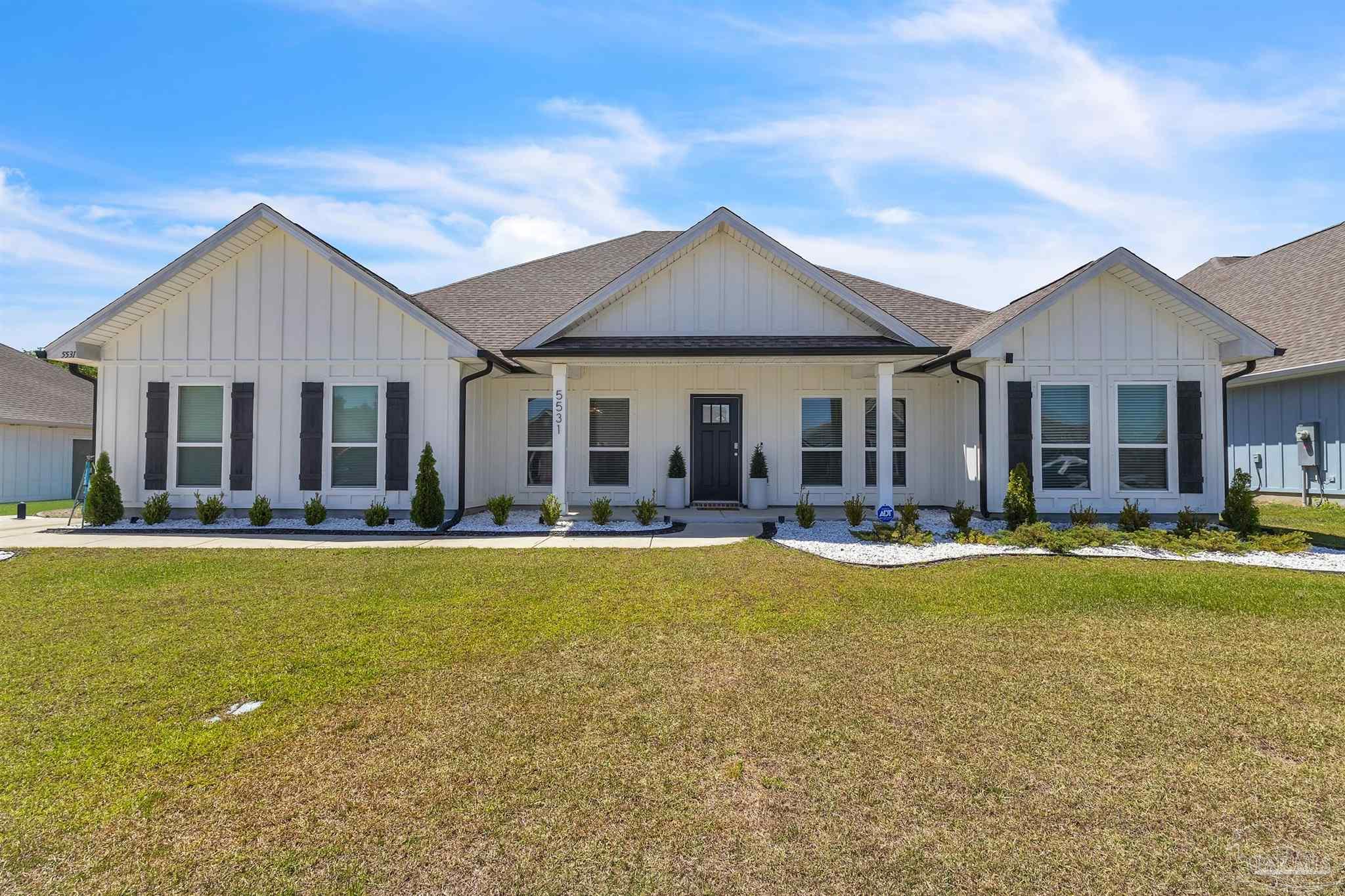 5531 Blake Lane Pace, FL 32571 - Photo 2 of 43 a front view of a house with swimming pool having outdoor seating