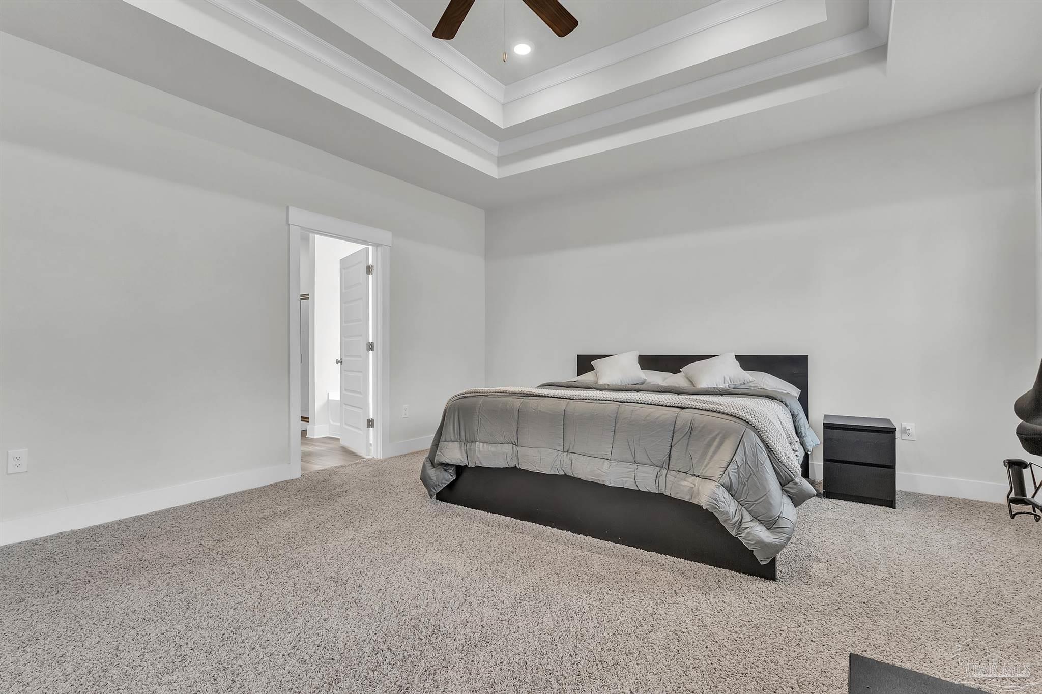 5531 Blake Lane Pace, FL 32571 - Photo 22 of 43 a bedroom with a bed and a chandelier