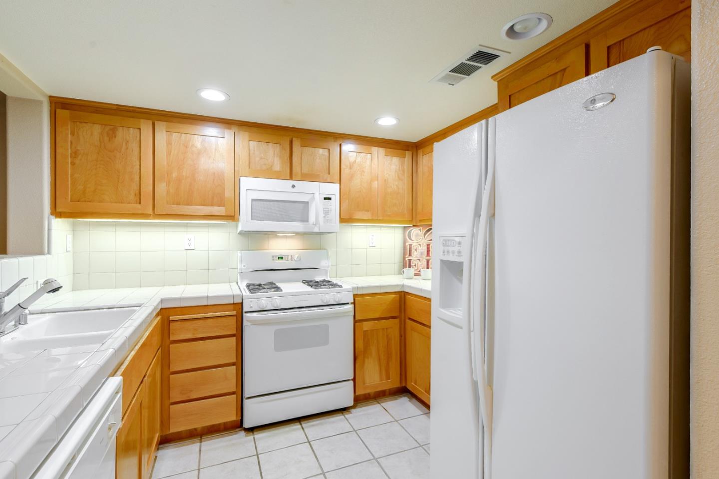 1476 Alegria Loop San Jose, CA 95128 - Photo 9 of 25 a kitchen with a sink a stove a refrigerator and window