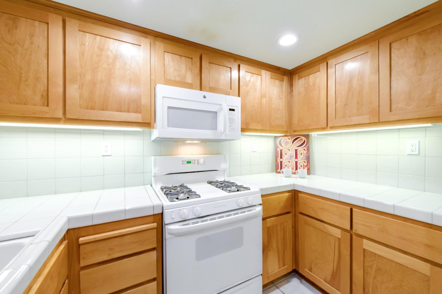 1476 Alegria Loop San Jose, CA 95128 - Photo 10 of 25 a kitchen with a stove a sink and a microwave