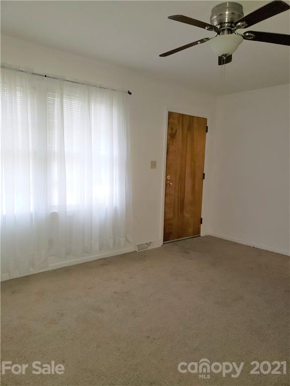 3718 Morgan Mill Road Monroe, NC 28110 - Photo 2 of 13 an empty room with a empty space and windows