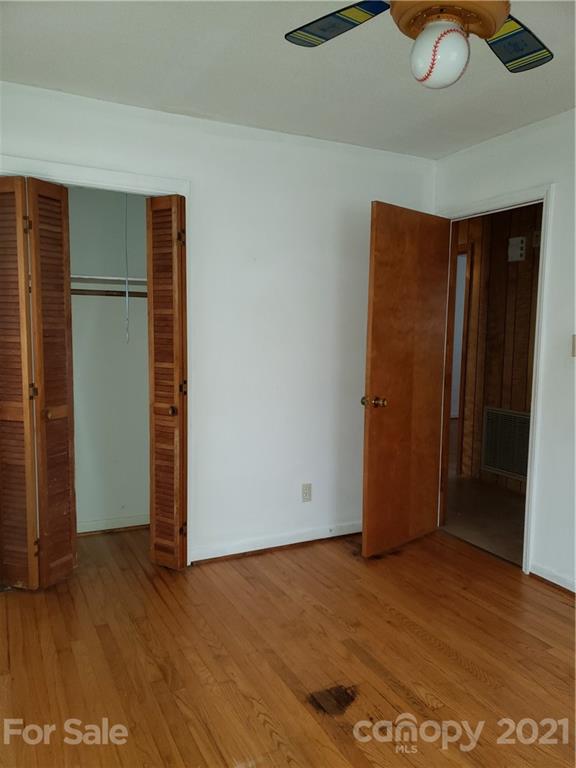 3718 Morgan Mill Road Monroe, NC 28110 - Photo 12 of 13 an empty room with wooden floor closet and windows