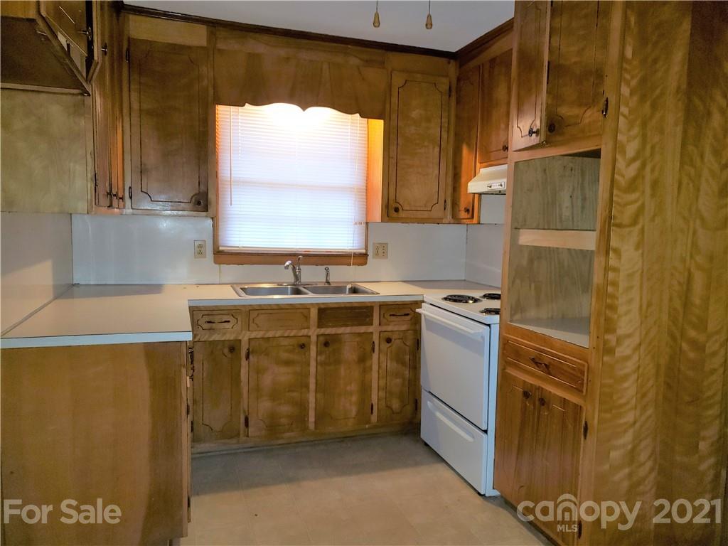 3718 Morgan Mill Road Monroe, NC 28110 - Photo 3 of 13 a kitchen with a cabinets and a stove top oven