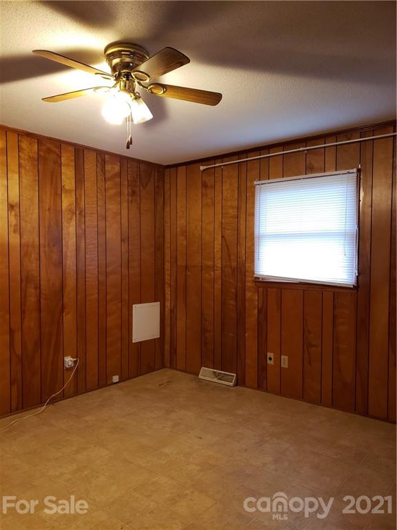 3718 Morgan Mill Road Monroe, NC 28110 - Photo 5 of 13 en empty room with windows and fan