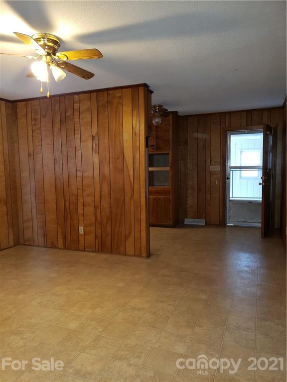 3718 Morgan Mill Road Monroe, NC 28110 - Photo 6 of 13 an empty room with windows chandelier fan and windows