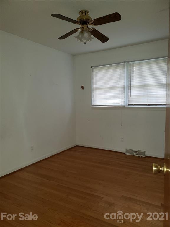 3718 Morgan Mill Road Monroe, NC 28110 - Photo 10 of 13 en empty room with wooden floor and windows