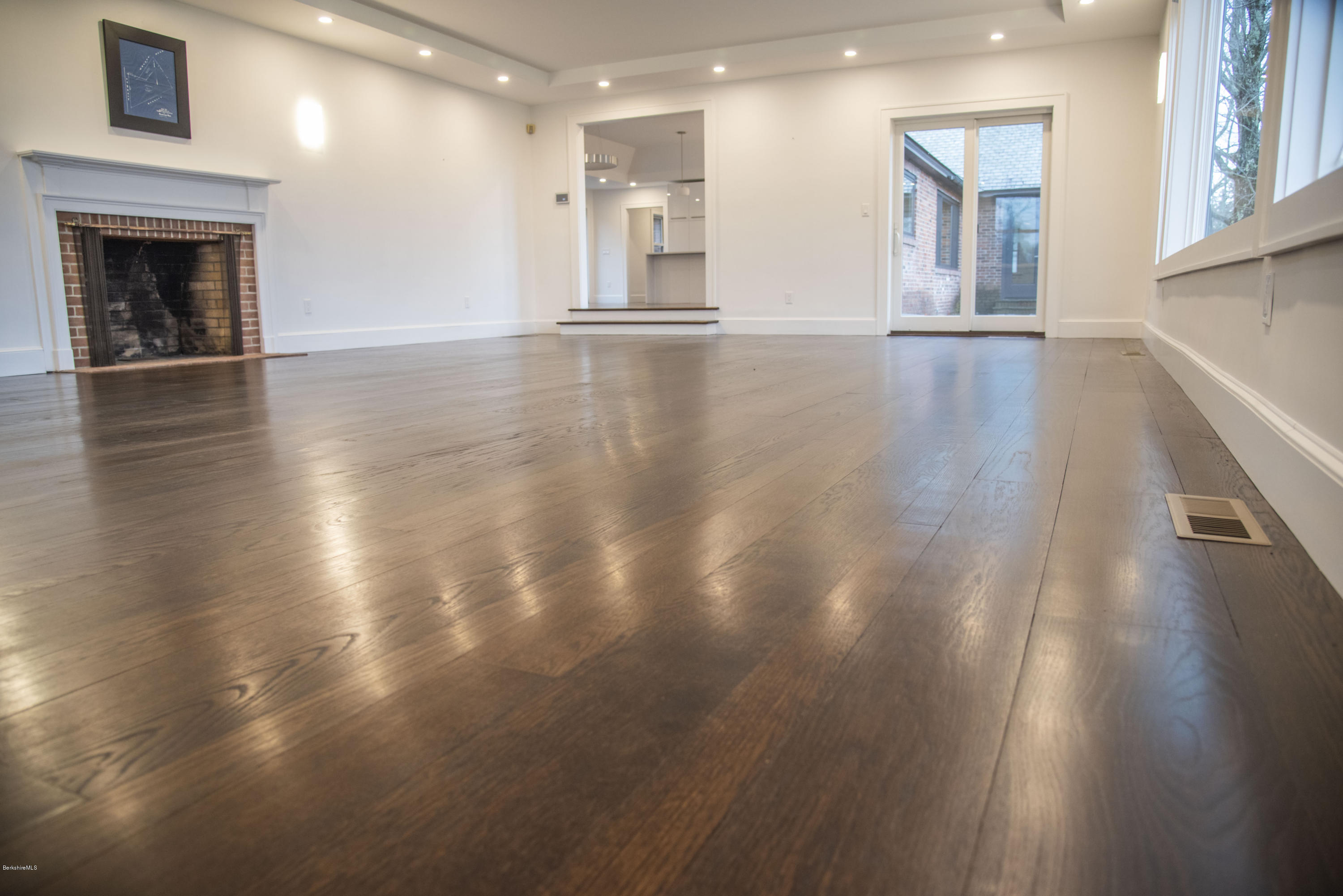 22 Prospect Hill Road Stockbridge, MA 01262 - Photo 39 of 78 a view of an empty room with wooden floor and a fireplace