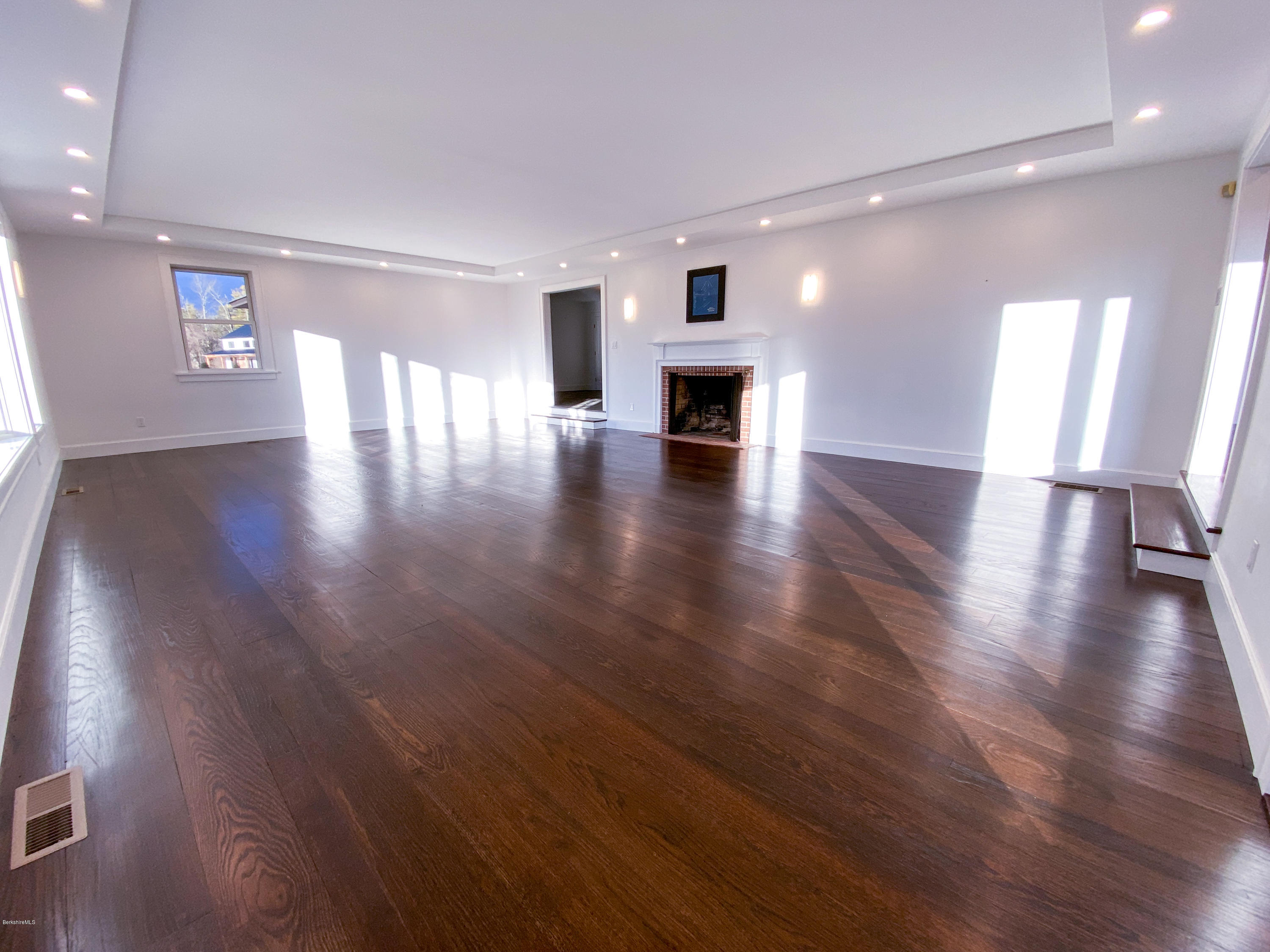 22 Prospect Hill Road Stockbridge, MA 01262 - Photo 44 of 78 a view of empty room with wooden floor and fireplace
