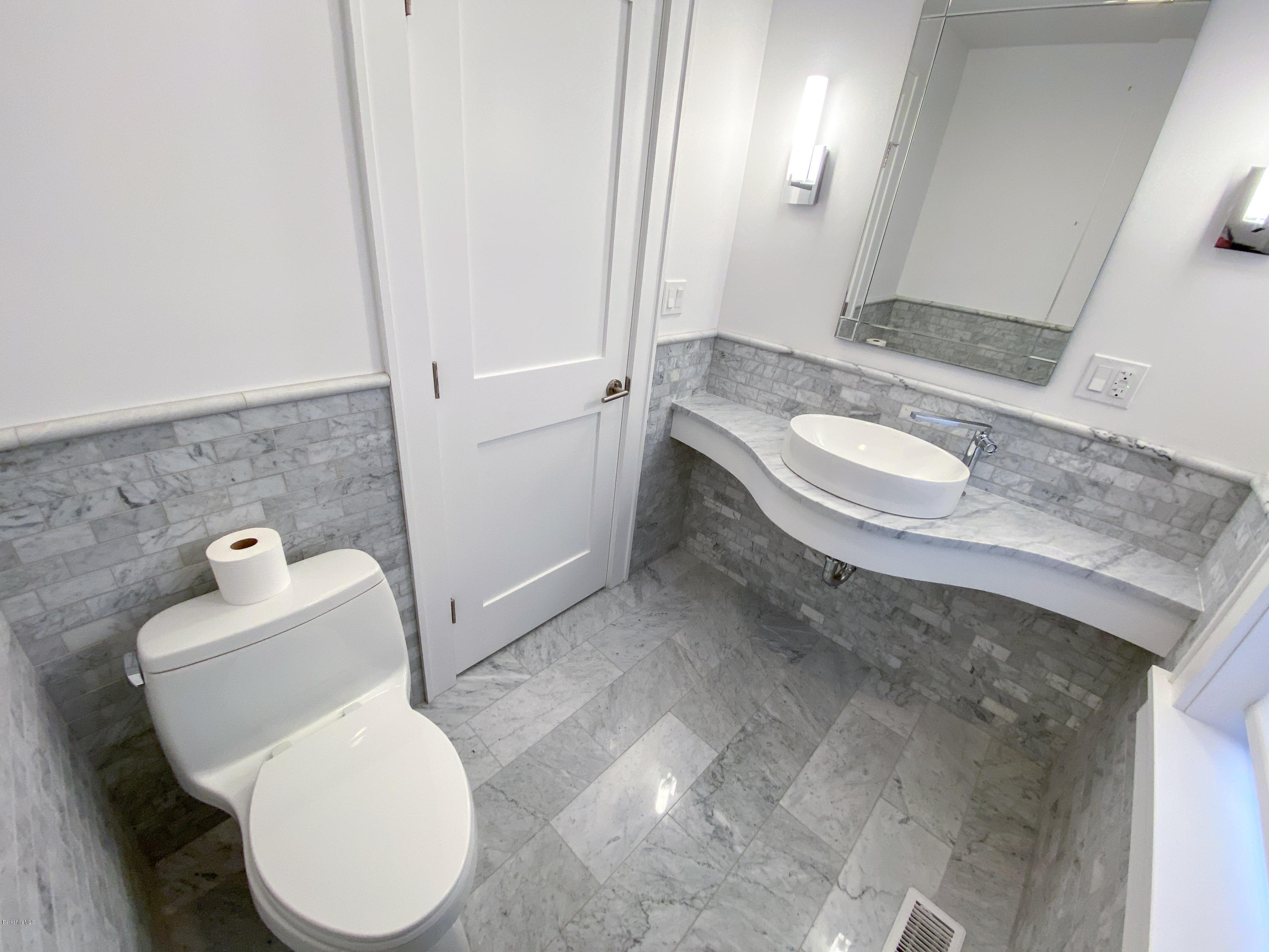 22 Prospect Hill Road Stockbridge, MA 01262 - Photo 45 of 78 a bathroom with a granite countertop toilet and a sink