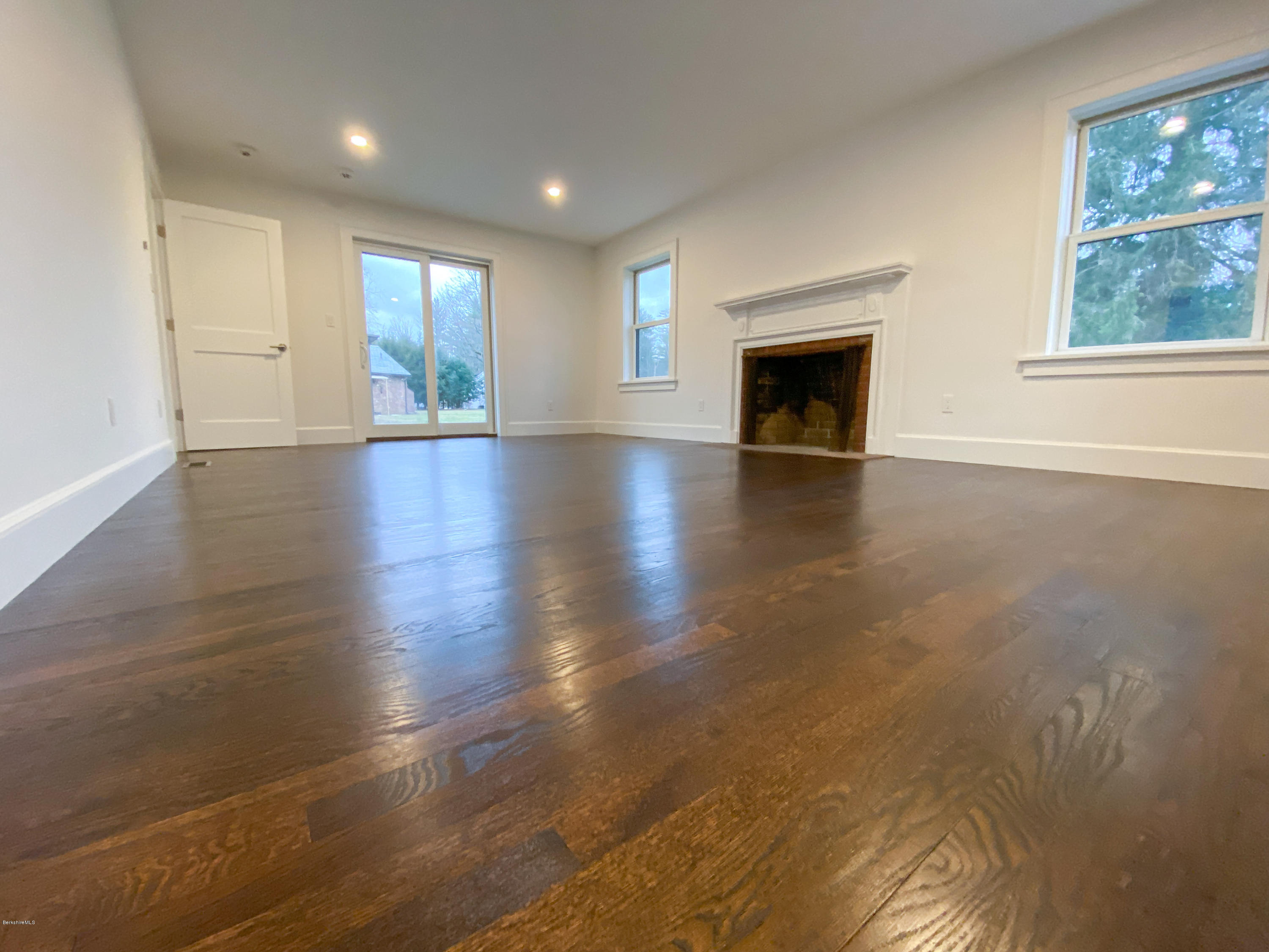 22 Prospect Hill Road Stockbridge, MA 01262 - Photo 53 of 78 an empty room with windows fireplace and wooden floor