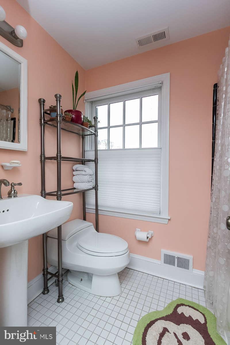 205 Longwood Road Baltimore, MD 21210 - Photo 15 of 30 a bathroom with a sink toilet and mirror